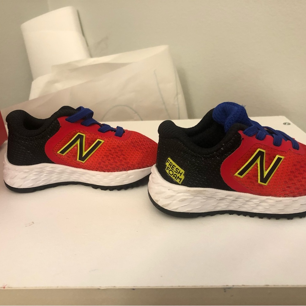 New Balance Kids Red and Black Sneakers with Yellow and Blue Details